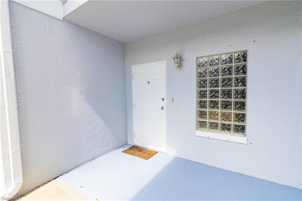 Entrance to property featuring stucco siding