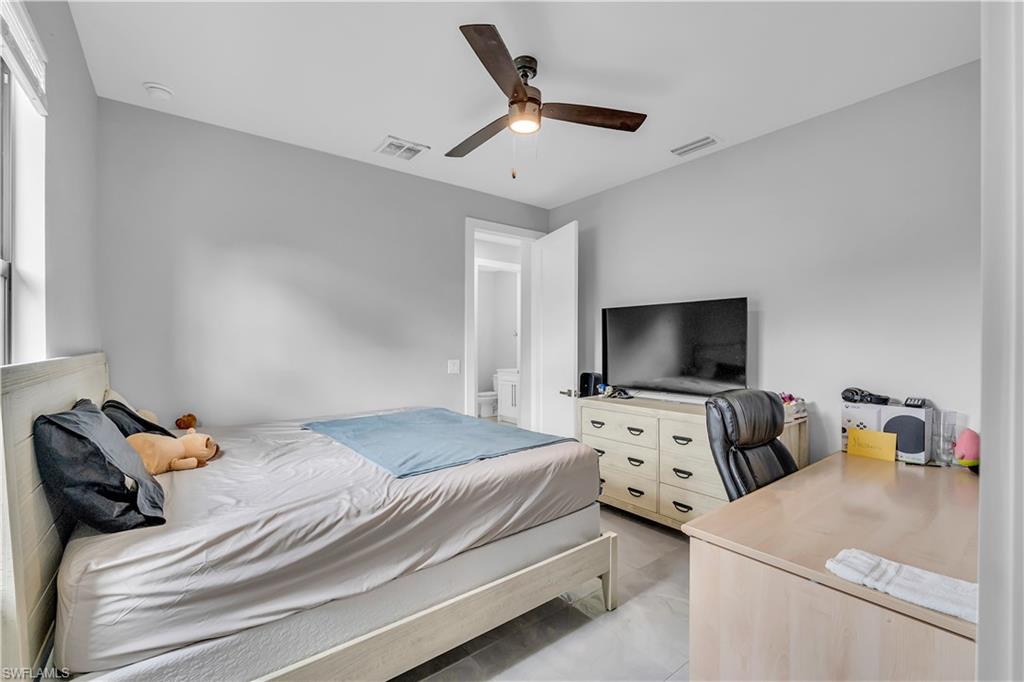 Bedroom featuring a ceiling fan and an office area