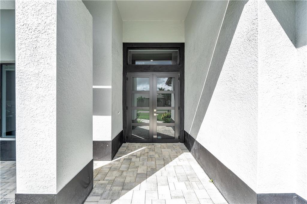 Entrance to property featuring french doors and stucco siding