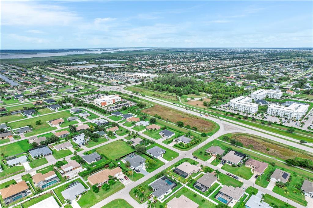 Aerial overview of property's location featuring nearby suburban area