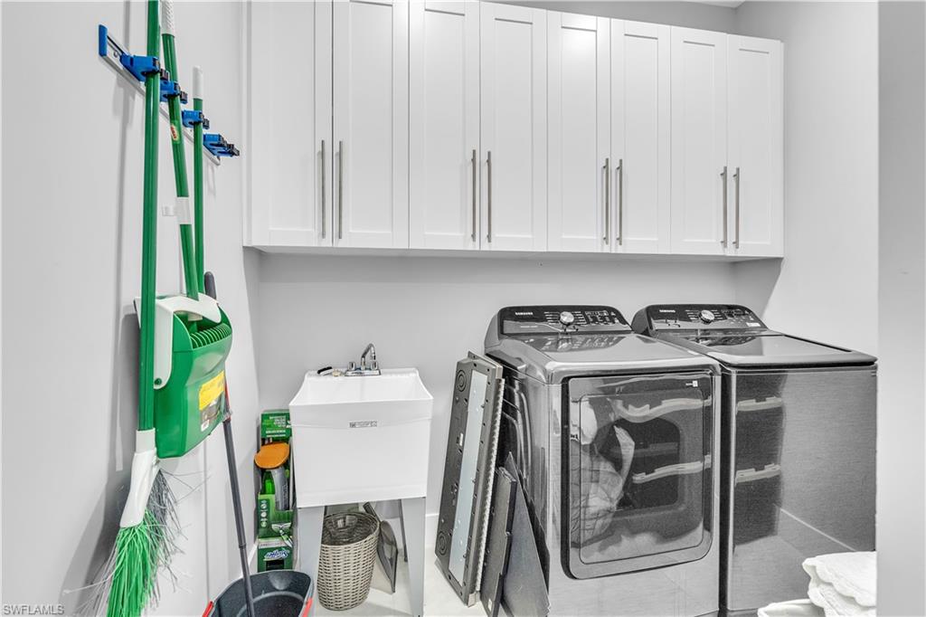 Laundry area with washer and clothes dryer and cabinet space