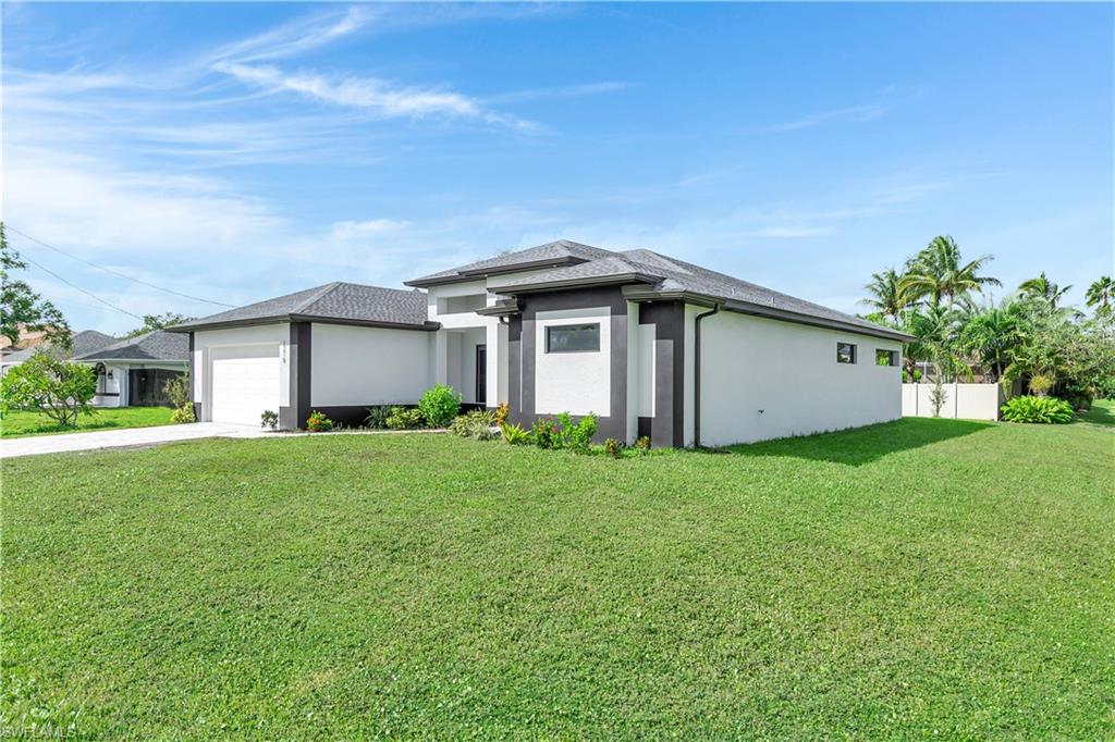 Prairie-style house with stucco siding, concrete driveway, and a garage