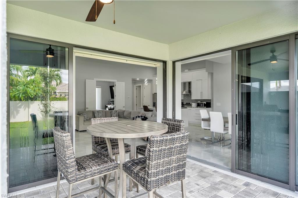 View of patio with outdoor dining area and a ceiling fan