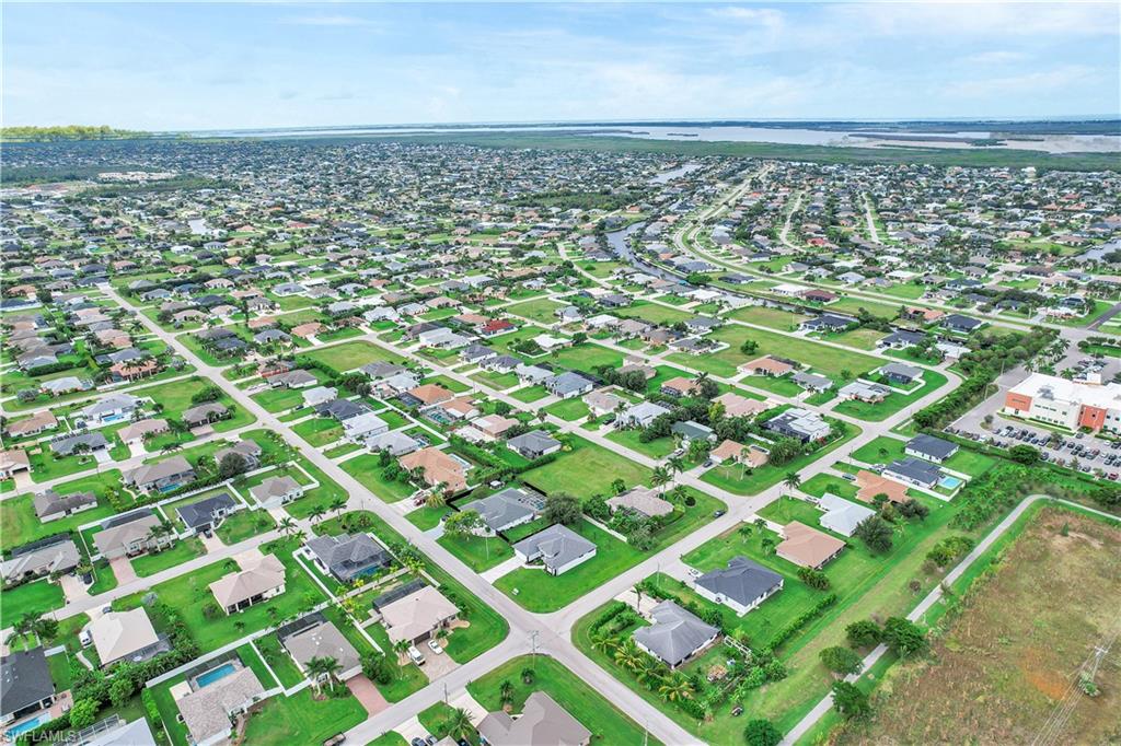 Aerial view of property's location with nearby suburban area and a large body of water
