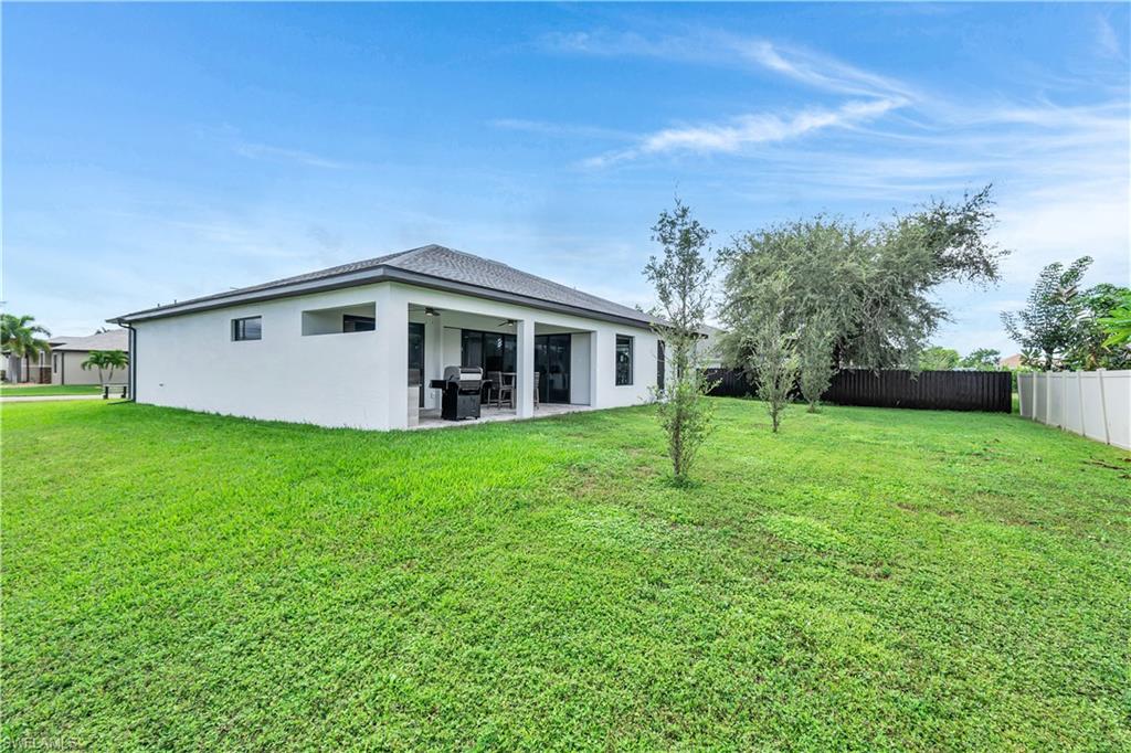Back of property featuring a patio, stucco siding, a fenced backyard, and a ceiling fan