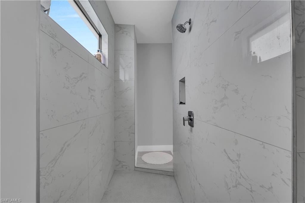 Full bathroom featuring a marble finish shower