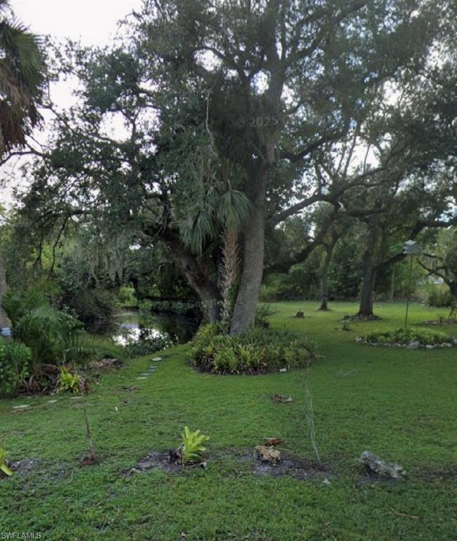 View of grassy area featuring a water view of Billy’s Creek