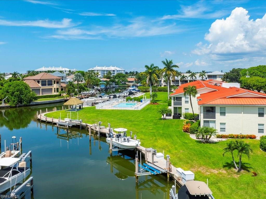 Dock area featuring boat lift and a water view
