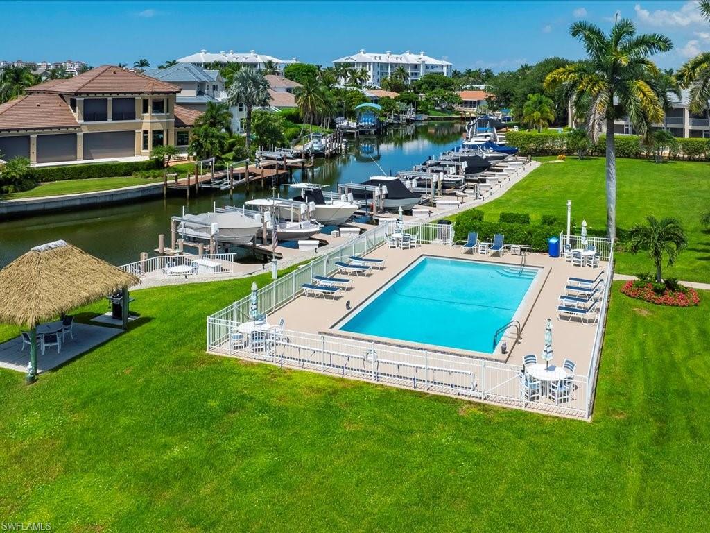 Community pool with a water view and a patio area