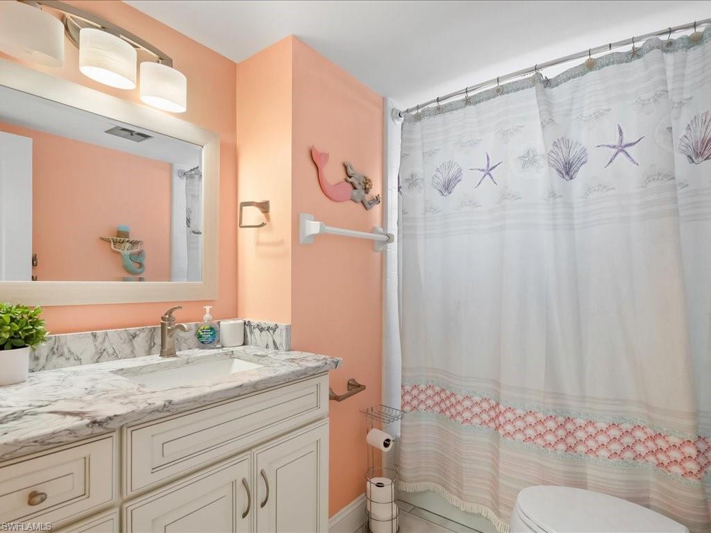 Full bath featuring vanity and toilet