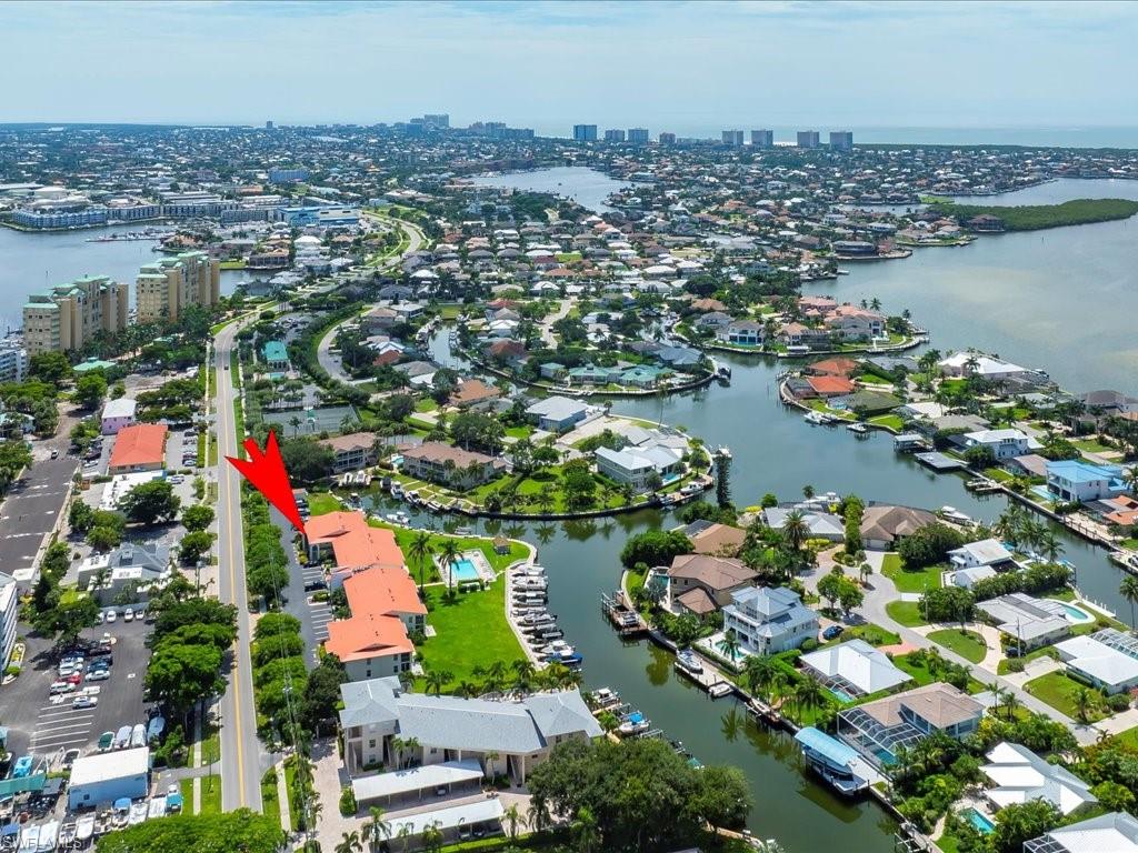 Aerial overview of property's location featuring a large body of water and nearby suburban area