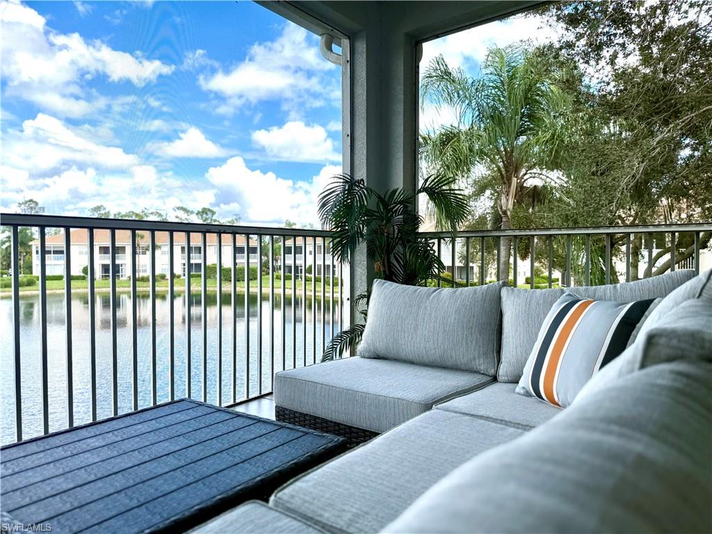 Balcony featuring a water view and an outdoor living space