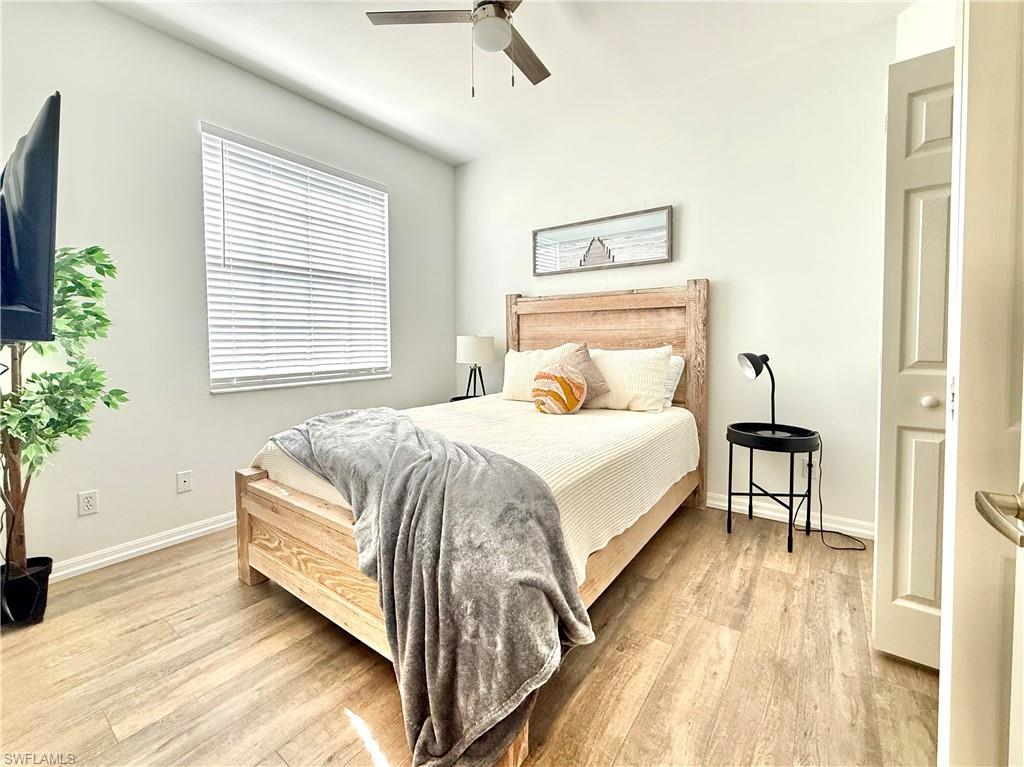 Bedroom with light wood-style floors and a ceiling fan