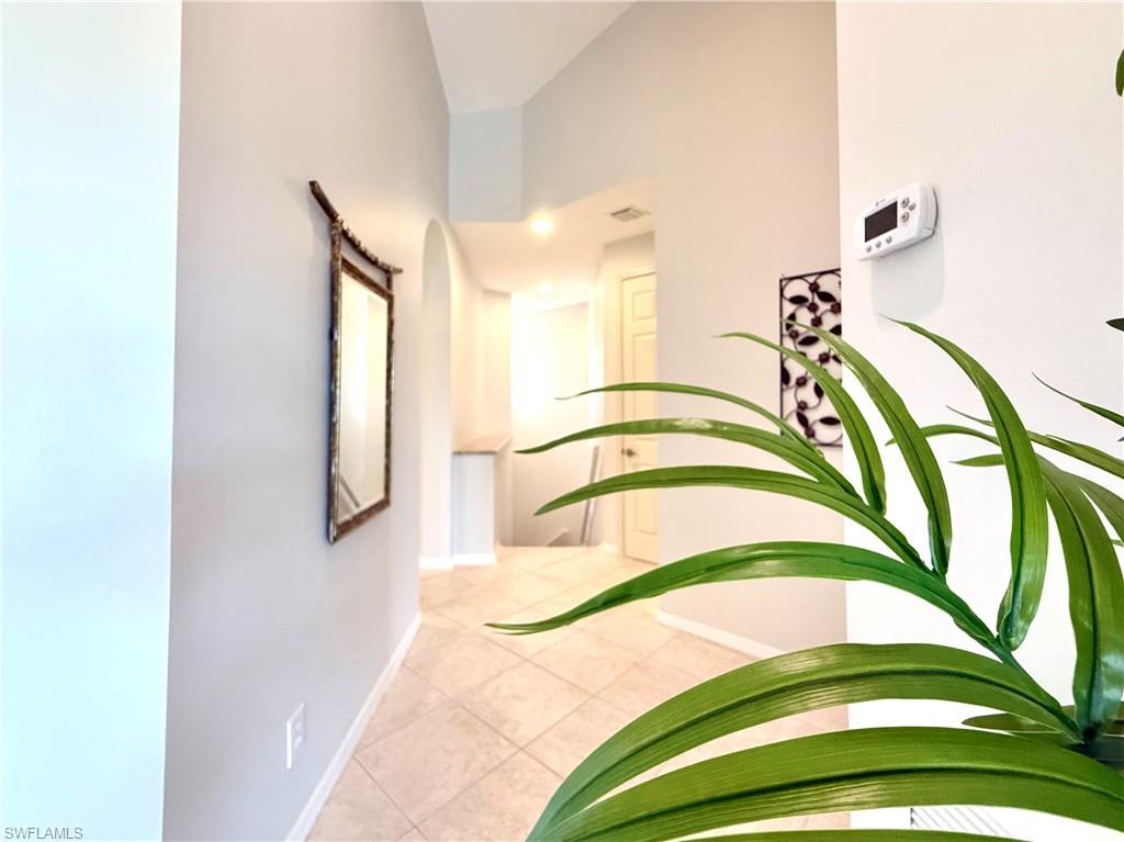Hallway featuring baseboards and tile patterned floors