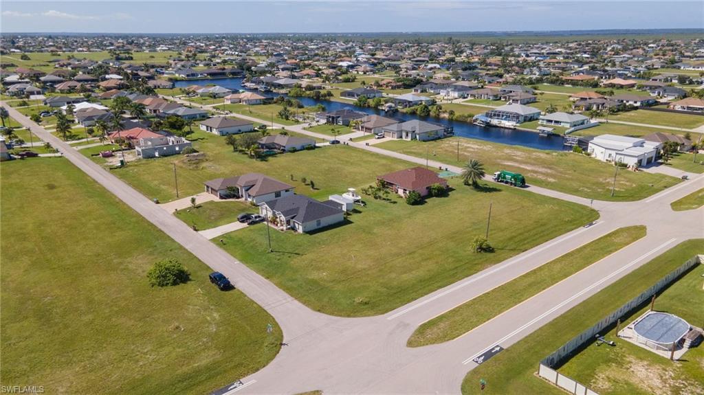 Aerial perspective of suburban area featuring a large body of water