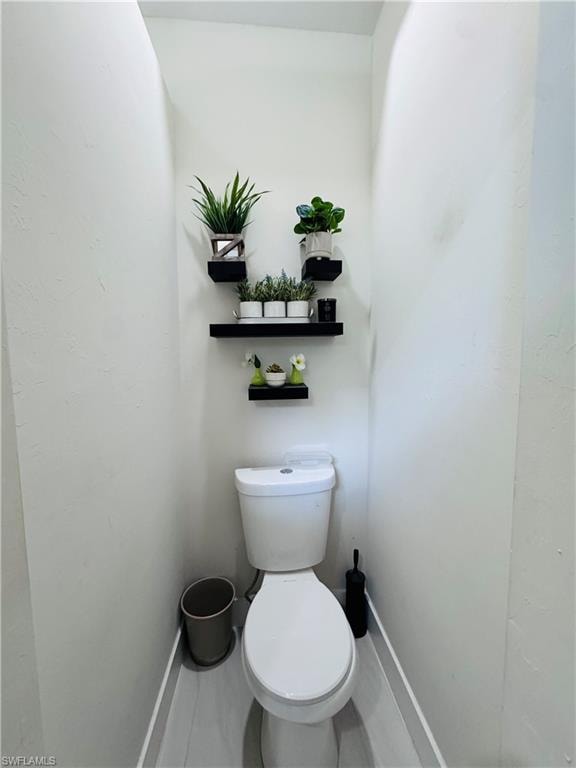 Bathroom featuring toilet and baseboards