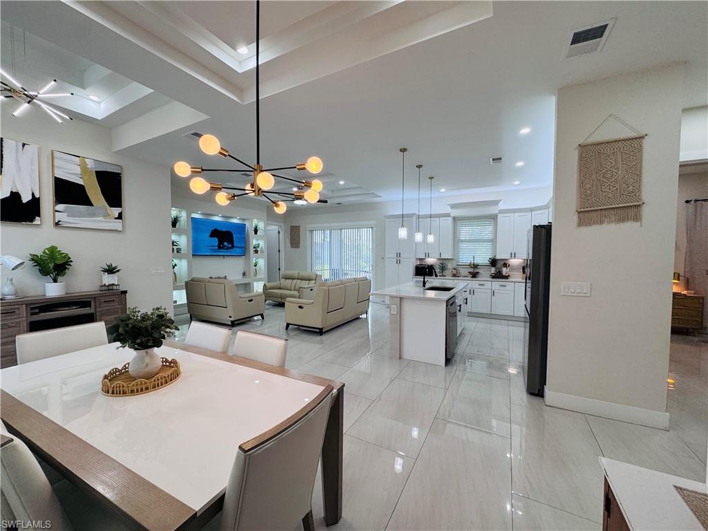 Dining area with a chandelier and recessed lighting