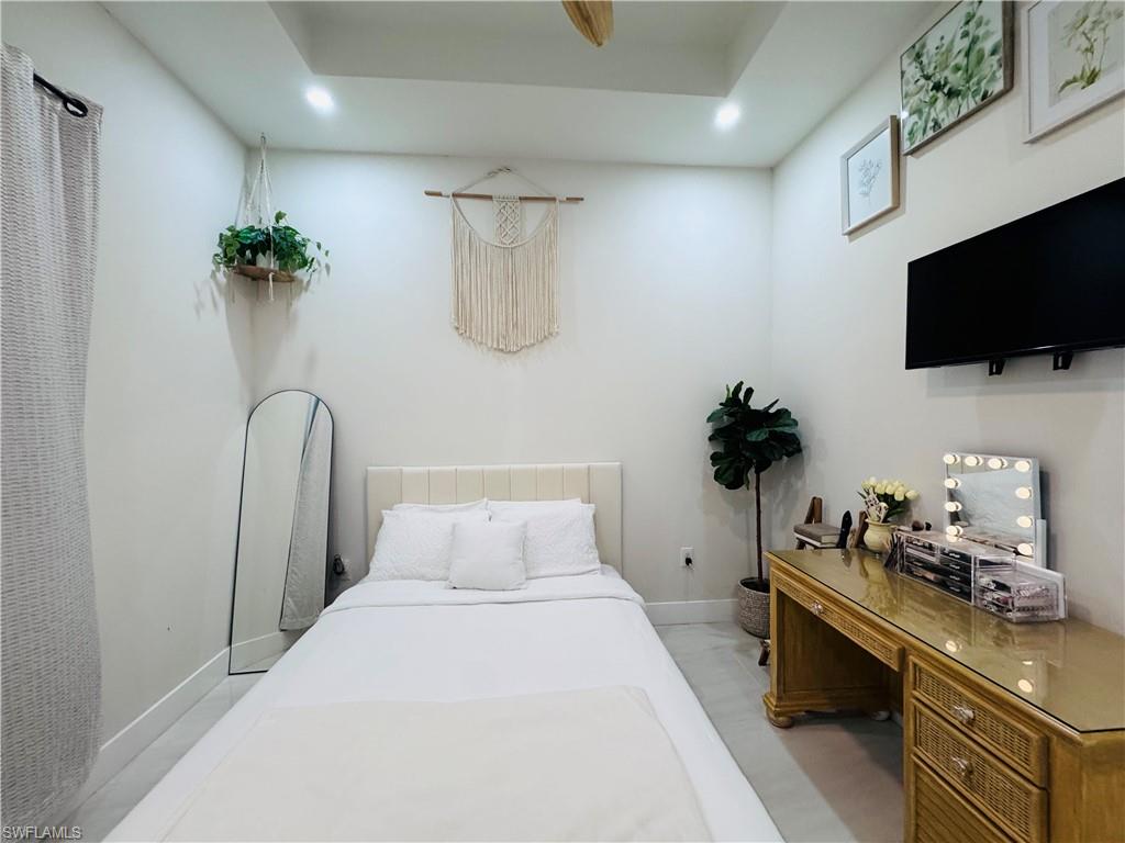 Bedroom with an office area and recessed lighting
