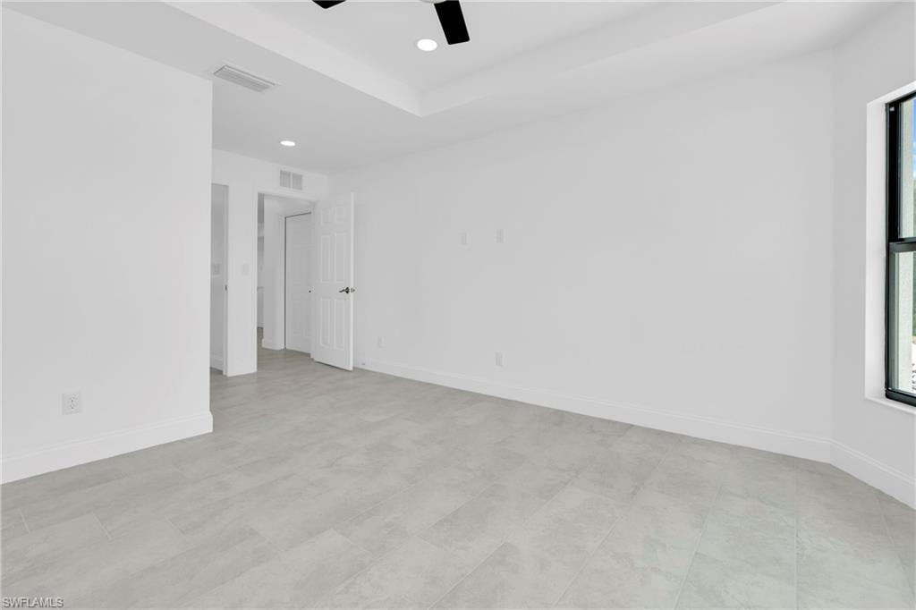 Unfurnished room with a ceiling fan, recessed lighting, and a raised ceiling