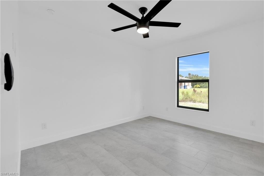 Spare room with baseboards and ceiling fan