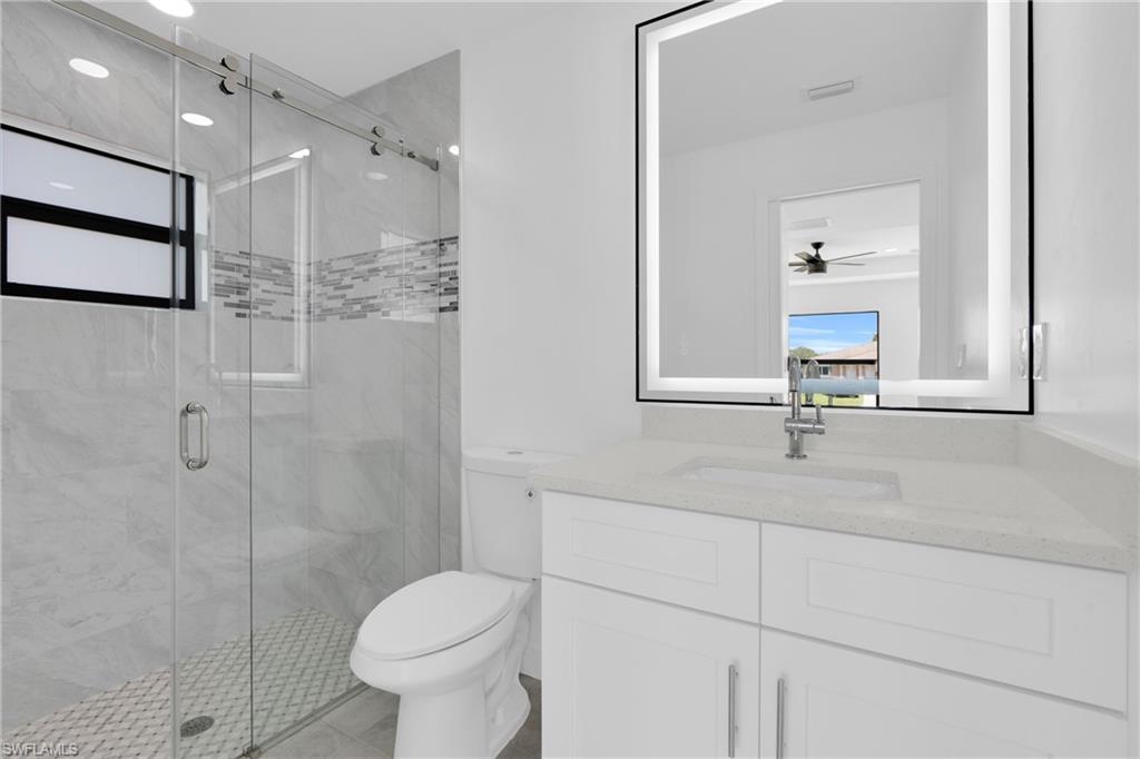 Full bathroom featuring vanity and a stall shower
