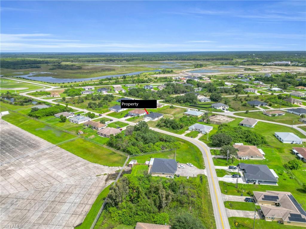 Aerial view of residential area featuring a nearby body of water