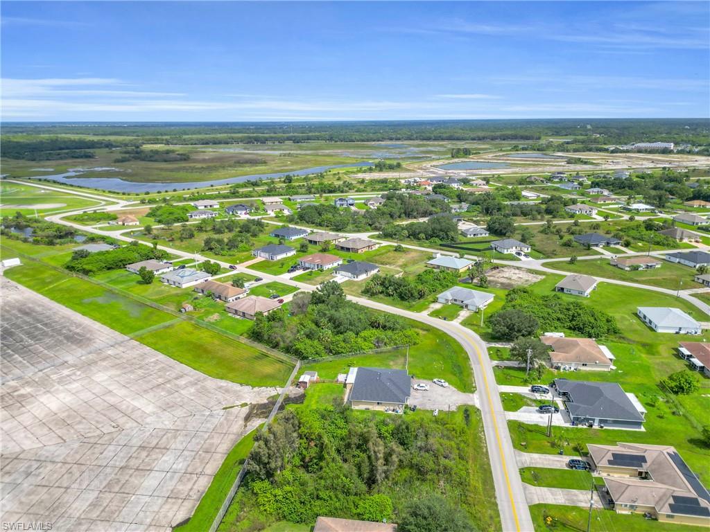 Aerial perspective of suburban area featuring a large body of water