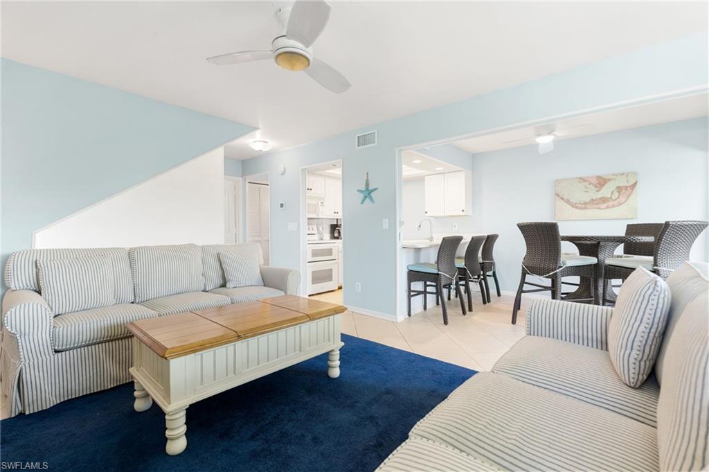 Living room featuring a ceiling fan and light tile patterned floors