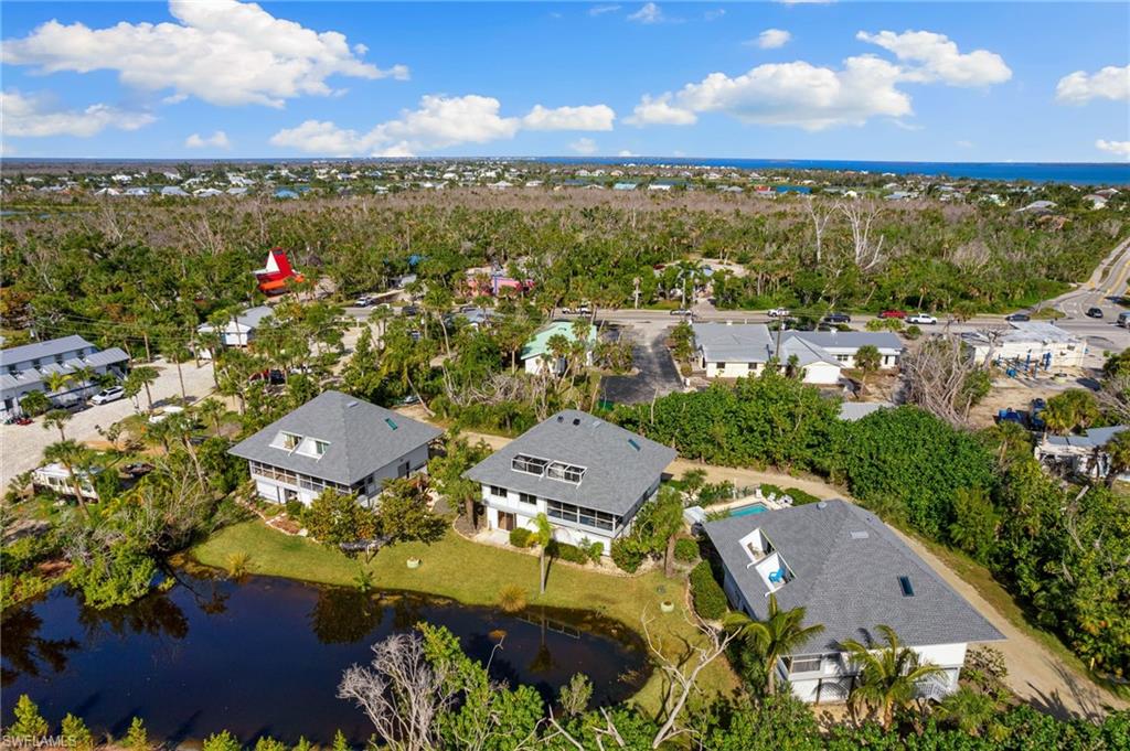 Aerial overview of property's location featuring a large body of water and nearby suburban area