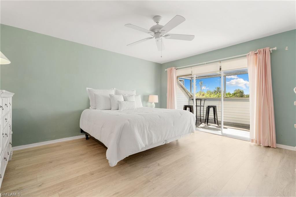 Bedroom with access to outside, light wood finished floors, and ceiling fan