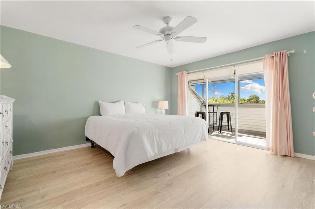 Bedroom featuring access to exterior, light wood-type flooring, and ceiling fan