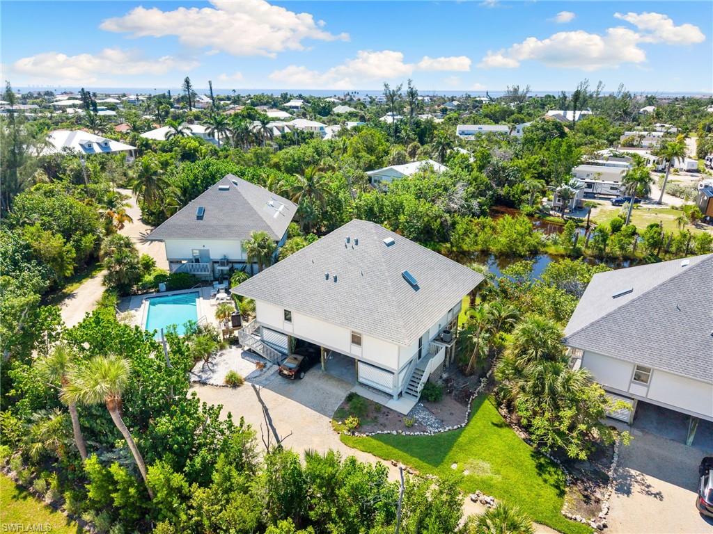 Aerial perspective of suburban area featuring a pool