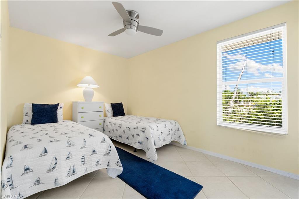 Bedroom featuring light tile patterned floors and ceiling fan