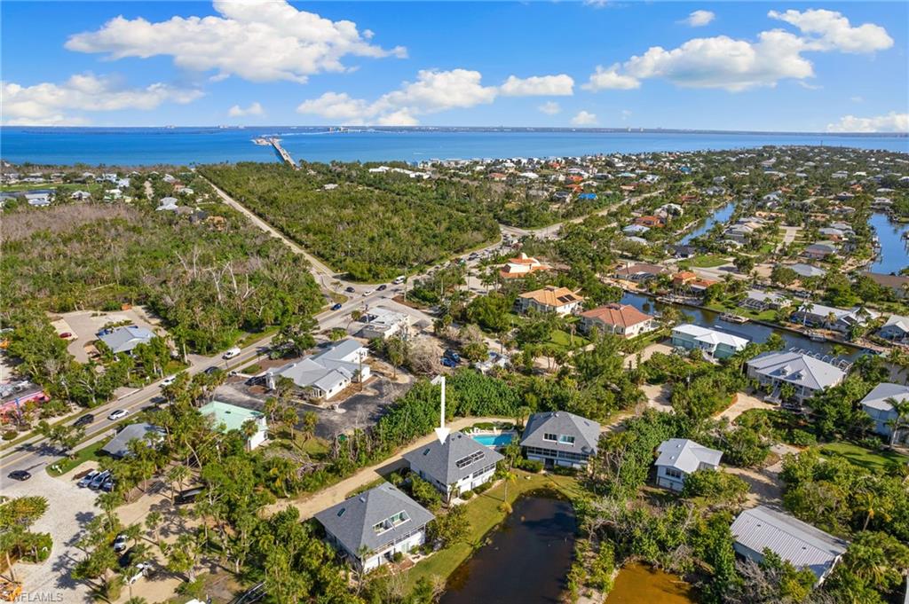 Aerial overview of property's location with nearby suburban area and a nearby body of water