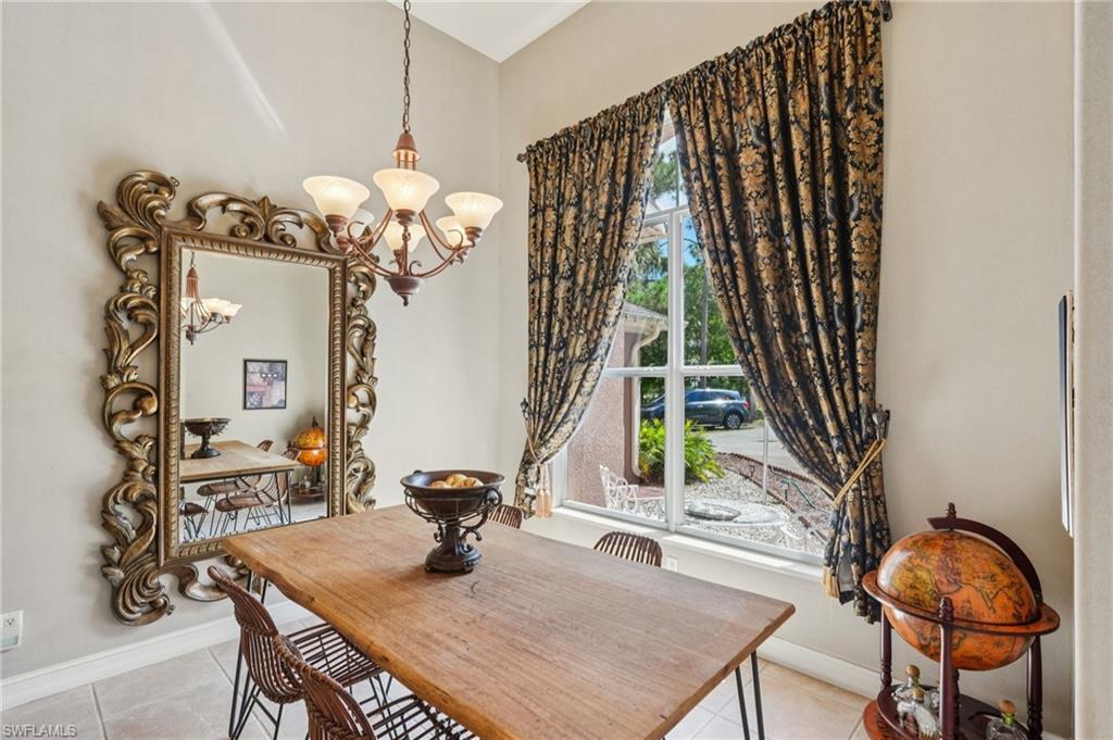 Dining space featuring light tile patterned floors and a chandelier