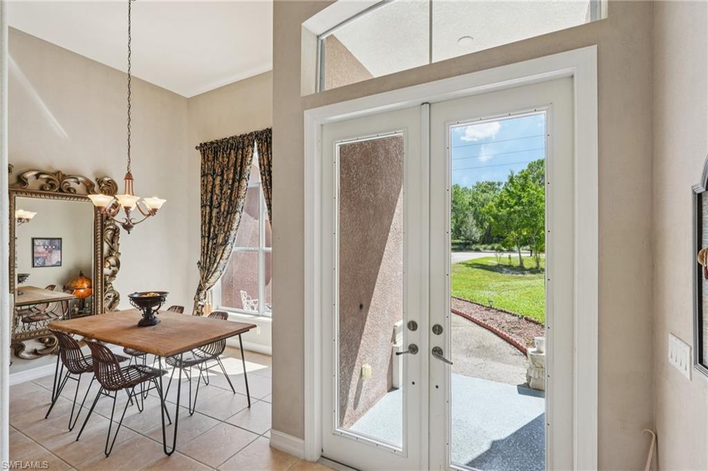 Entryway featuring french doors, healthy amount of natural light, and tile patterned flooring