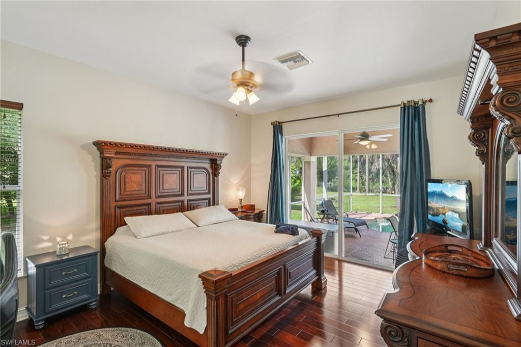 Bedroom featuring dark wood-style floors, a ceiling fan, and access to outside
