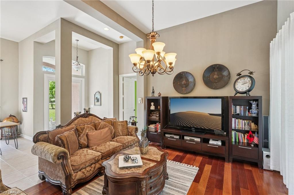 Living room with a chandelier and dark wood-type flooring