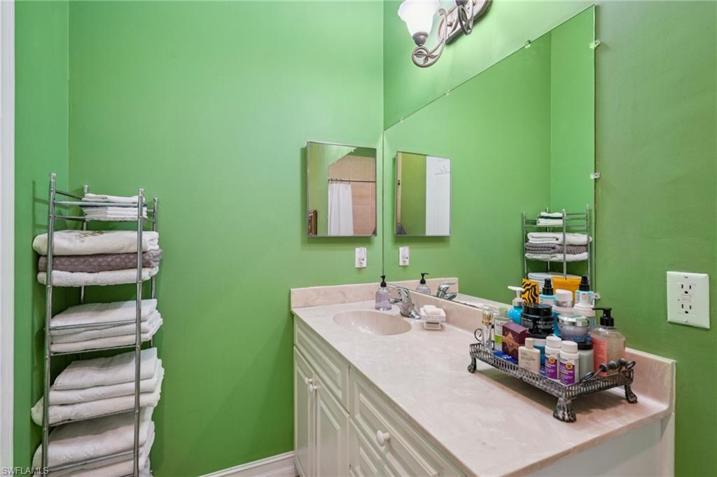 Full bathroom featuring vanity and baseboards