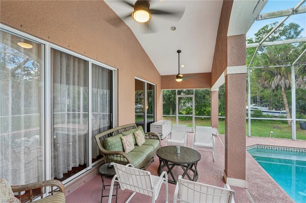 Sunroom with ceiling fan, a patio area, lofted ceiling, an outdoor hangout area, and healthy amount of natural light