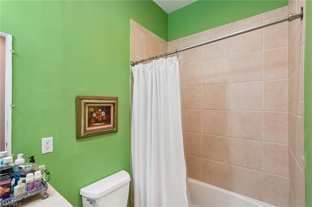 Full bath featuring shower / tub combo with curtain and vanity