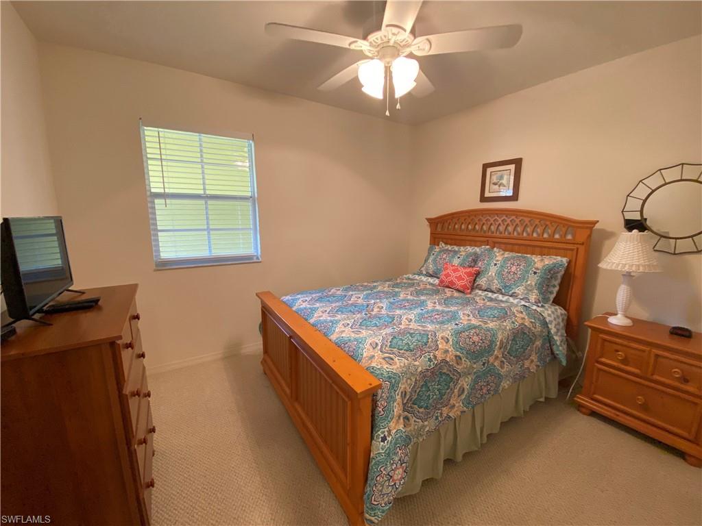Bedroom featuring light colored carpet and ceiling fan