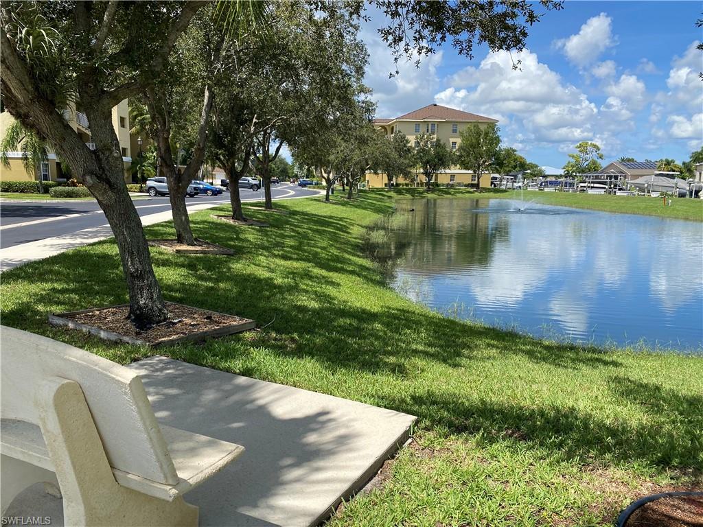 View of property's community with a water view and a yard