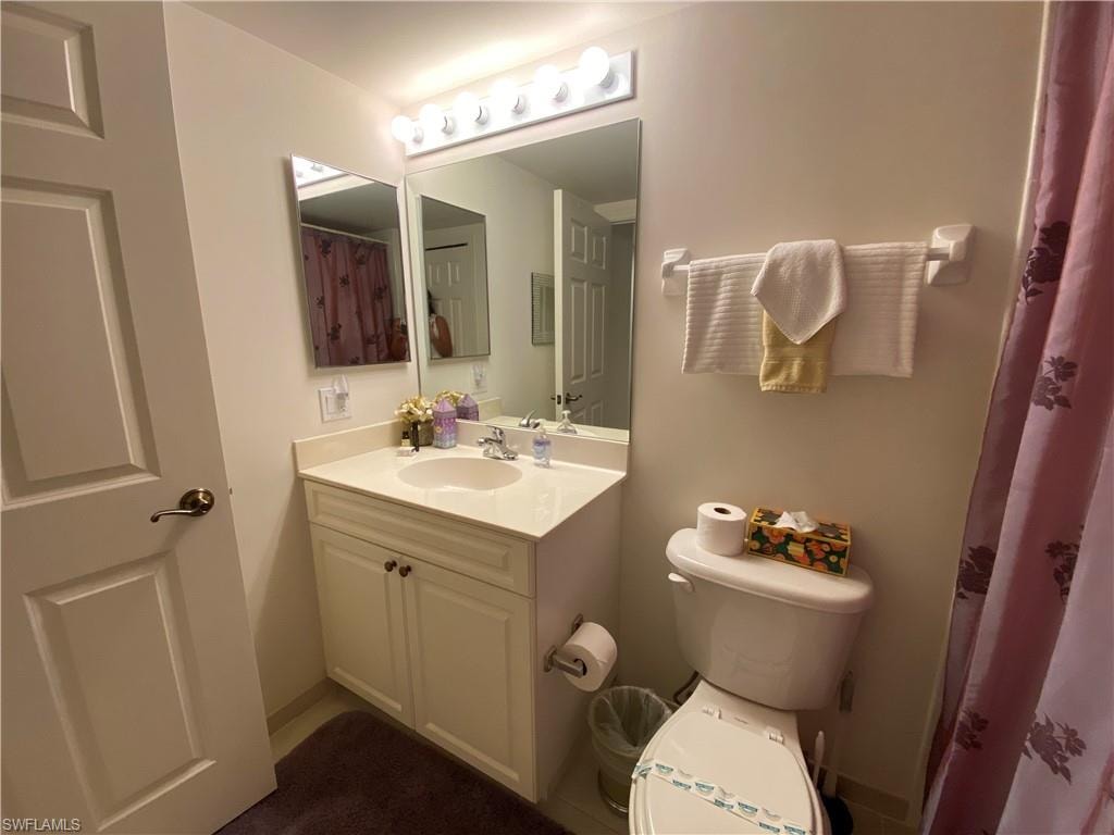Bathroom featuring vanity and curtained shower