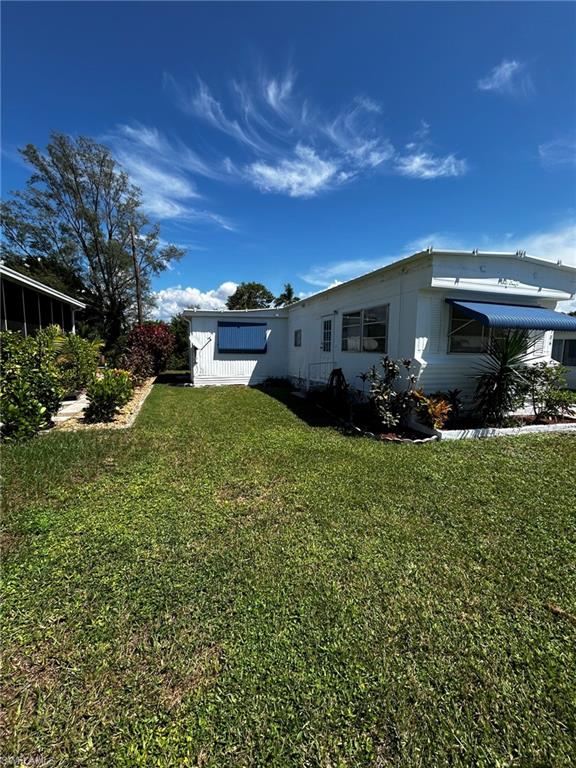 View of side of home with a lawn