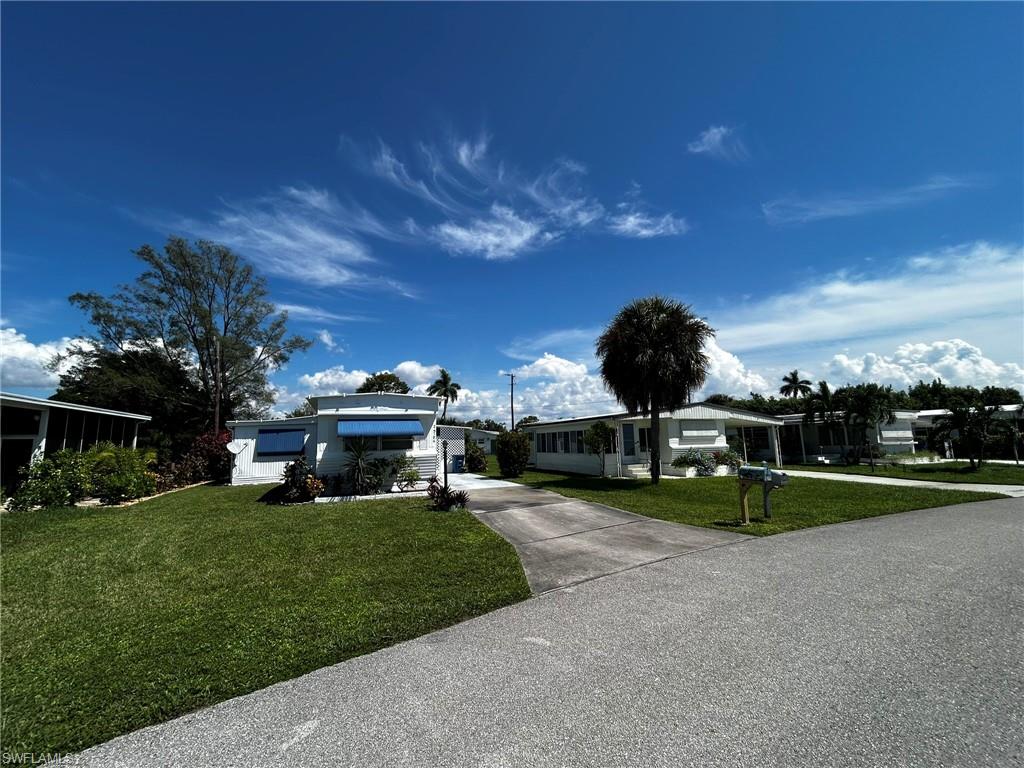 View of front of home featuring a front yard and driveway