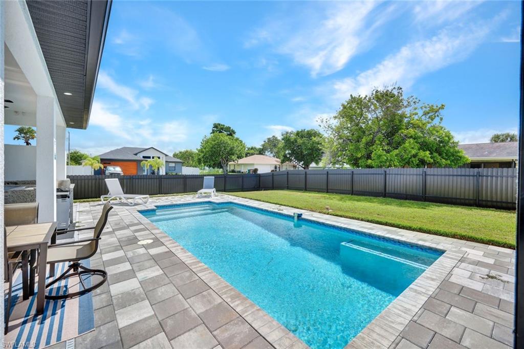 View of swimming pool featuring a patio and a fenced backyard
