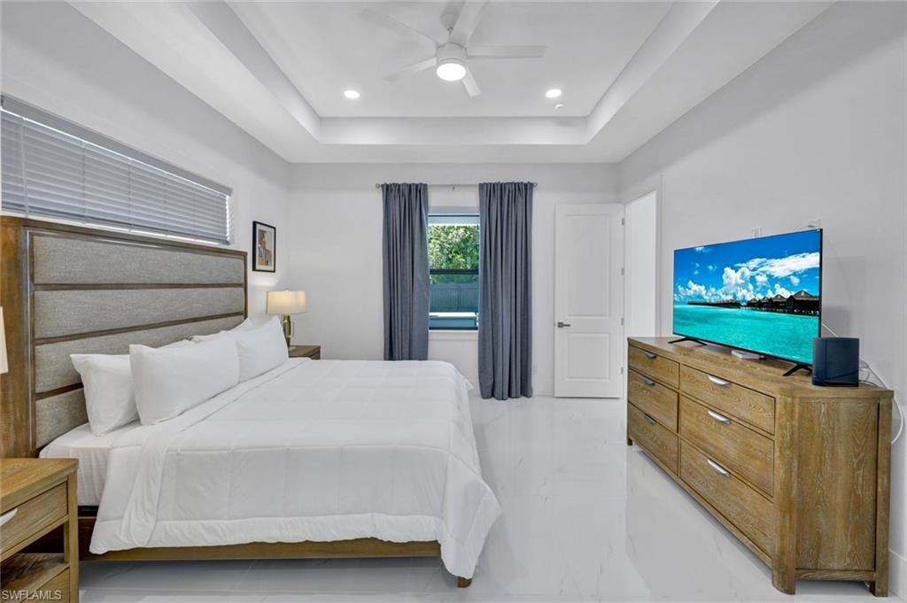 Bedroom featuring ceiling fan, recessed lighting, and a raised ceiling