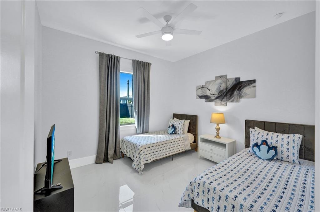 Bedroom with a ceiling fan and baseboards