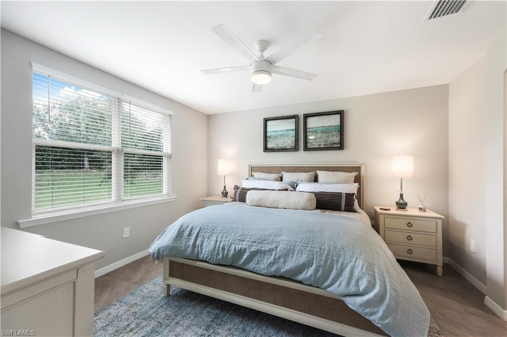 Bedroom featuring ceiling fan and baseboards
